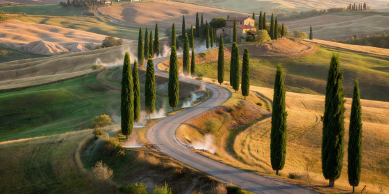 Tuscan thermal route winding through cypress trees and Val d'Orcia
